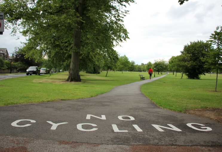 Painted 'no cycling' sign, Harrogate Stray