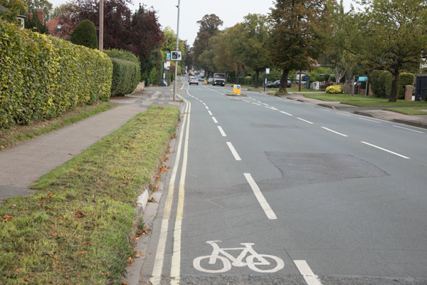 Narrow painted cycle lane heading toward the city centre